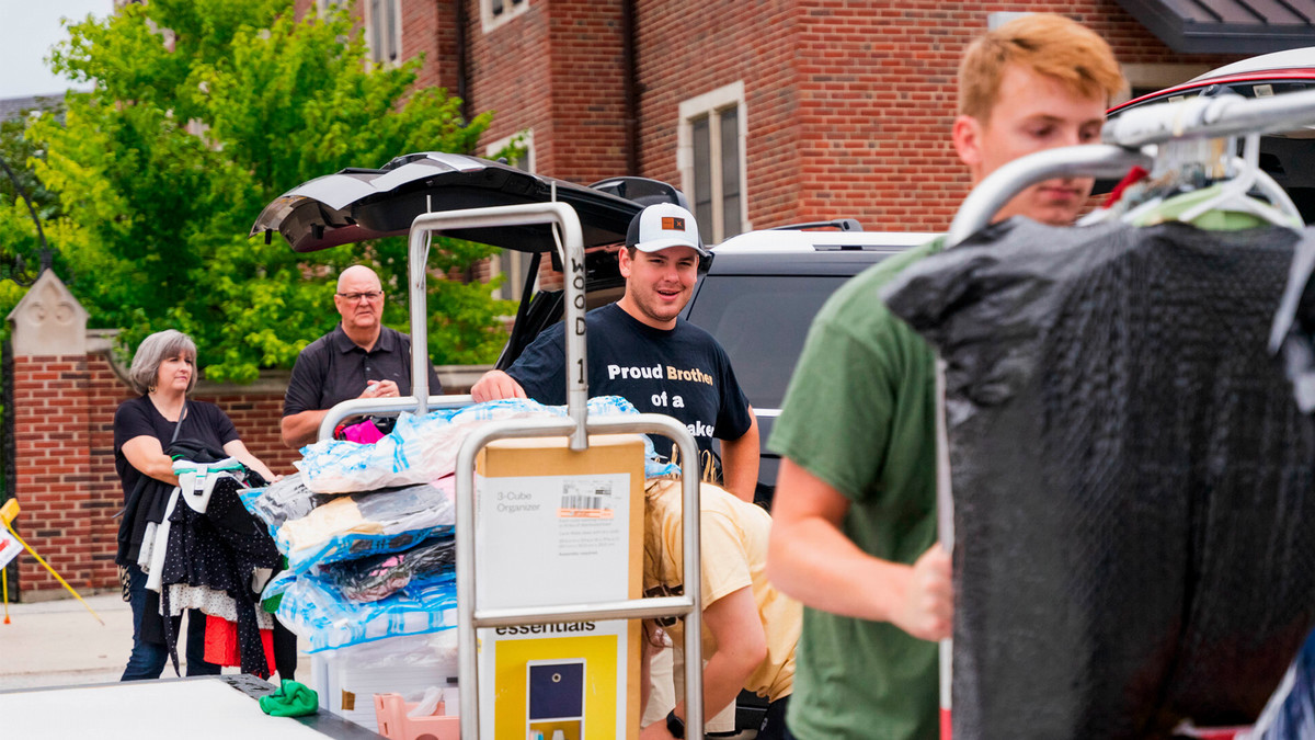 Students and parents moving in and out of dorms.