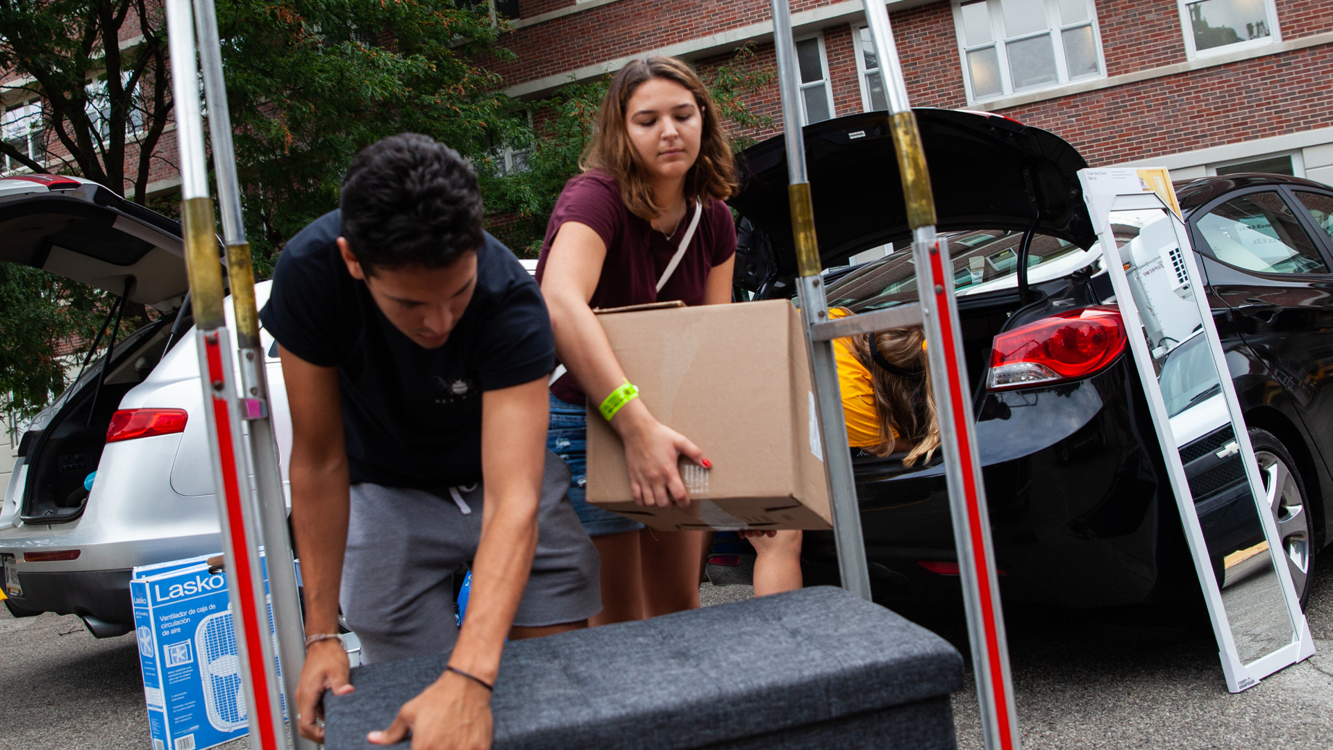 Student unloading boxes from a vehicle