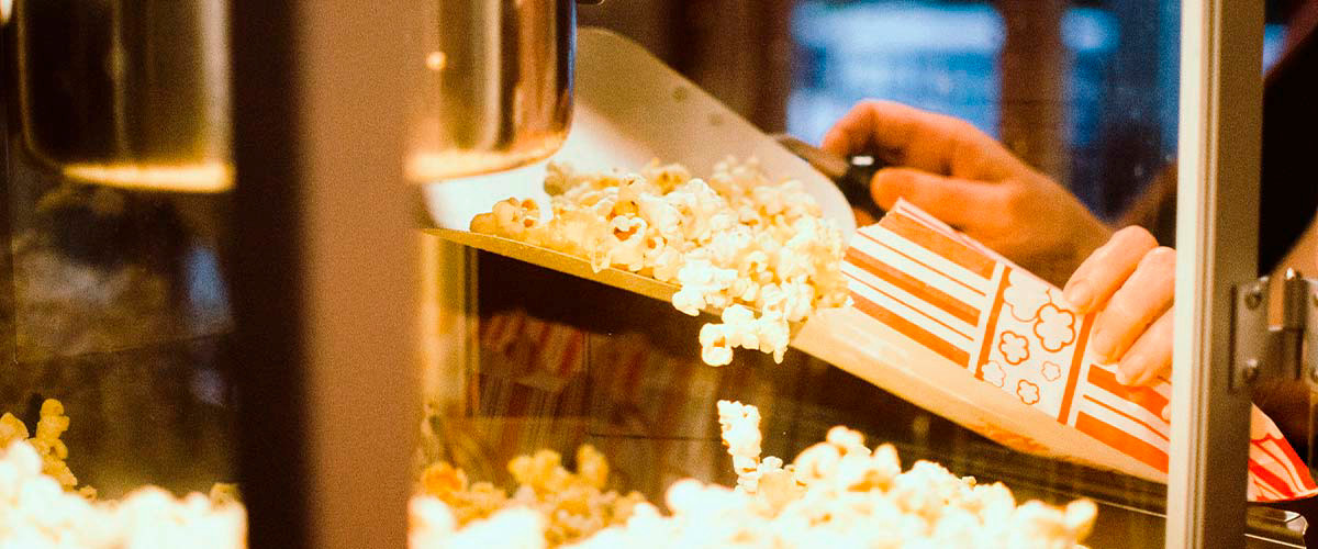 Person putting popcorn into a bag