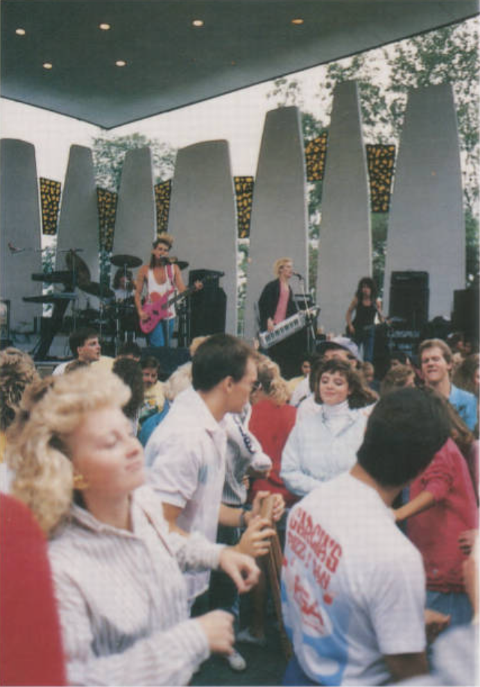 A band playing for a group of people at Slayter Hill.