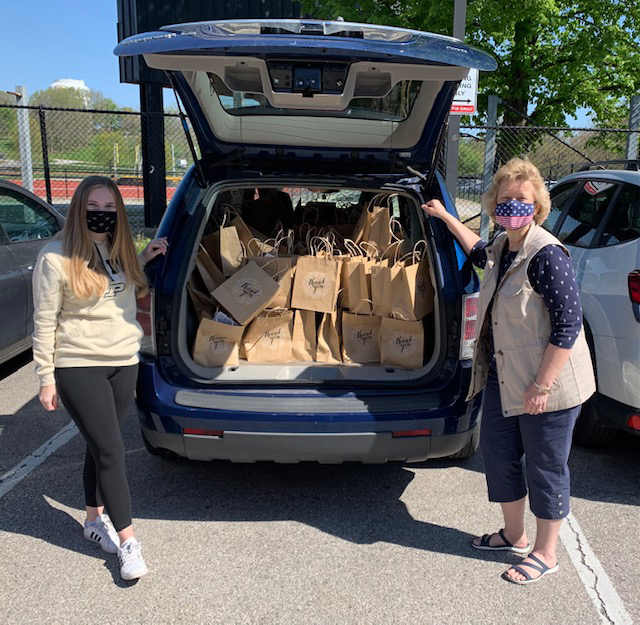 Susan Huffman (right) assists members of Alpha Lambda Delta Phi Eta Sigma in the delivery of care packages for Purdue COVID-19 vaccine clinic staff.