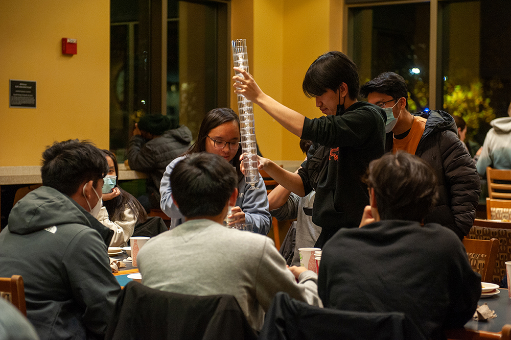 Students stack cups in Wiley Dining Court.