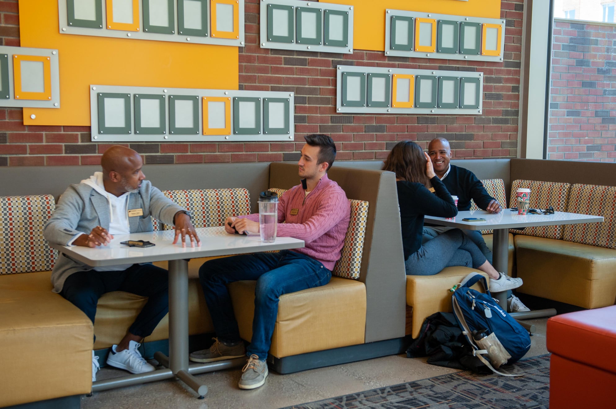 Rodrick Glass (far left) and Rodney Glass (far right) hold discussions during Coffee & Consulting.