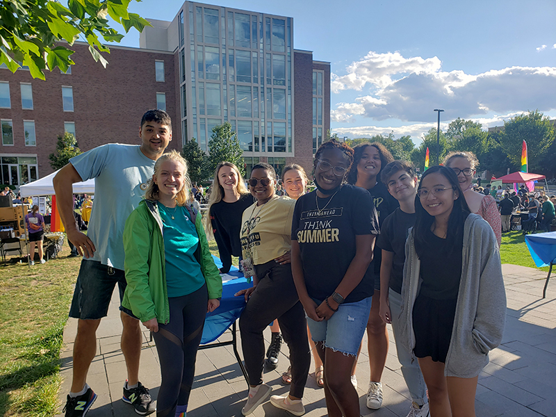 Christopher Cayari (far left) with students at Rainbow Callout, an event hosted by the LGBTQ Center.