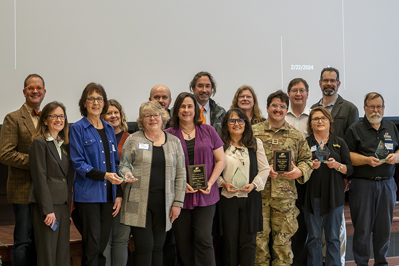 Learning community award winners pose with awards at banquet.