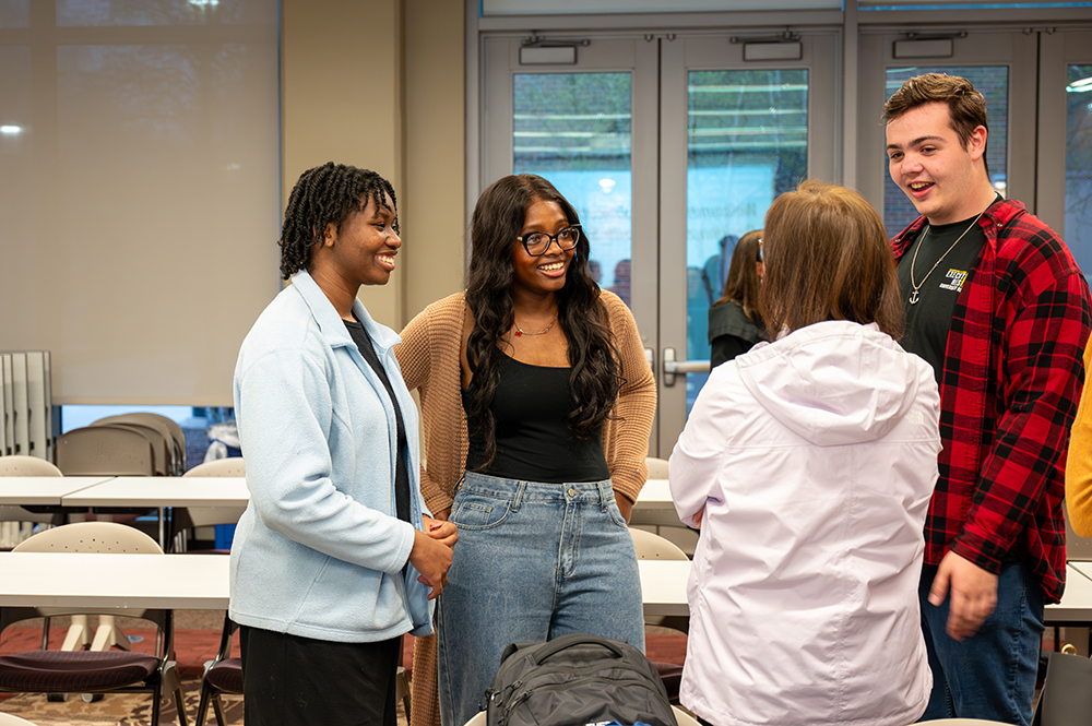 Students converse with executive.