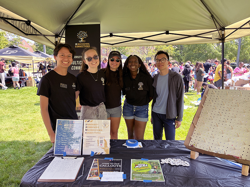 Students pose under tent