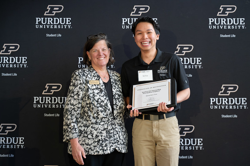 Smiling student receives award