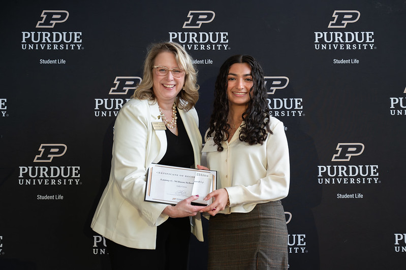 Smiling student receives award
